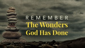 Stone cairn on green blurry background,  pebbles and stones